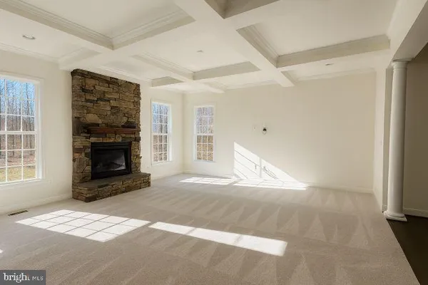 a view of empty room with a fireplace