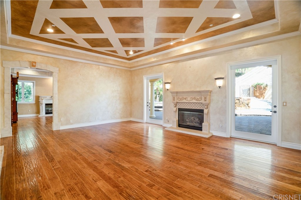 75 North Coolwater Road Bell Canyon, CA 91307 - Photo 12 of 72 a view of an empty room with wooden floor fireplace and windows
