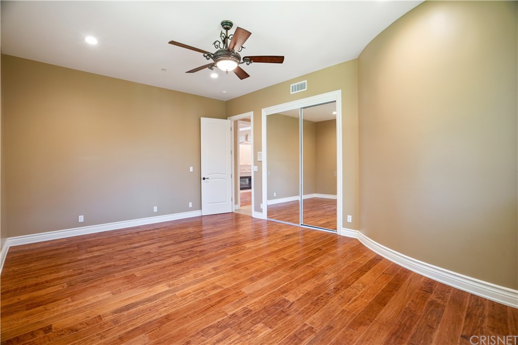 75 North Coolwater Road Bell Canyon, CA 91307 - Photo 17 of 72 an empty room with wooden floor and a ceiling fan
