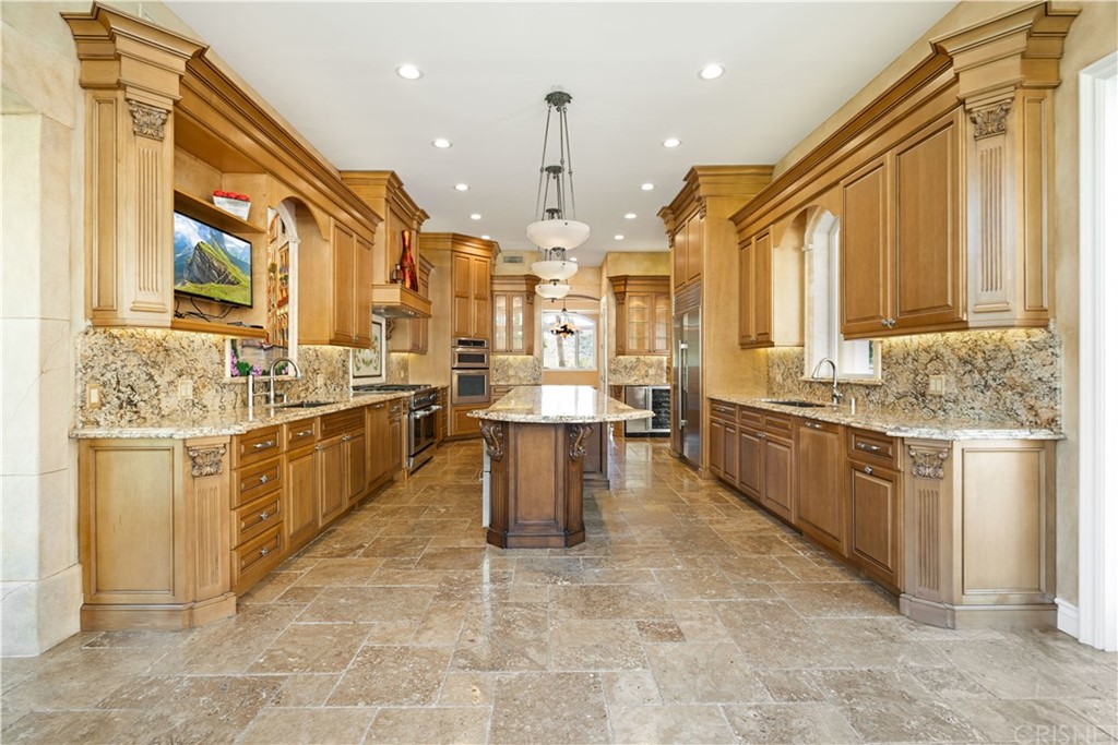 75 North Coolwater Road Bell Canyon, CA 91307 - Photo 21 of 72 a large kitchen with kitchen island granite countertop lots of white stainless steel appliances