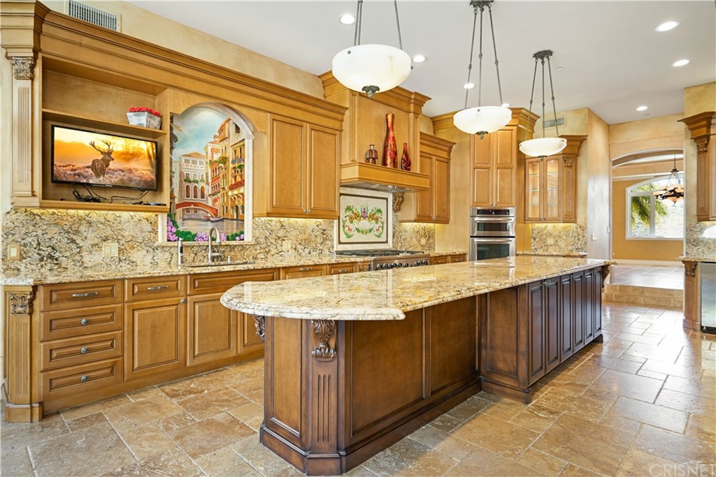 75 North Coolwater Road Bell Canyon, CA 91307 - Photo 22 of 72 a kitchen with stainless steel appliances granite countertop a sink a stove and a wooden floors