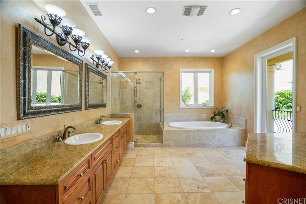 75 North Coolwater Road Bell Canyon, CA 91307 - Photo 31 of 72 a spacious bathroom with a granite countertop tub sink and mirror