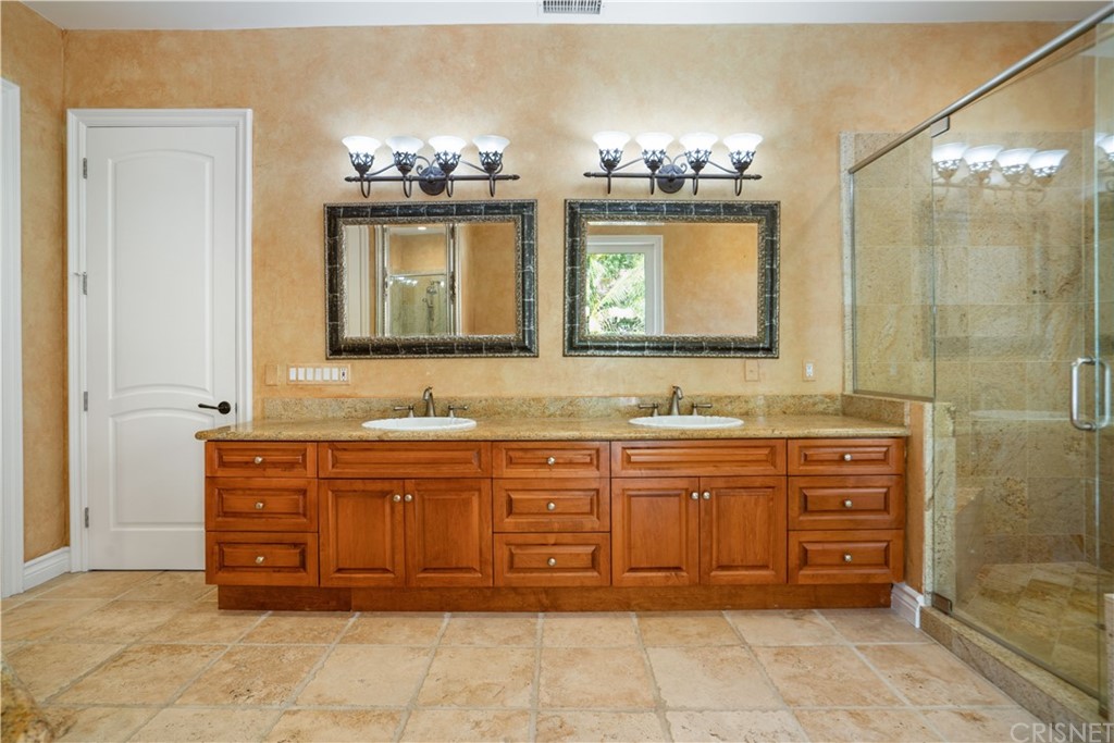 75 North Coolwater Road Bell Canyon, CA 91307 - Photo 33 of 72 a bathroom with a granite countertop double vanity sink mirror and bathtub