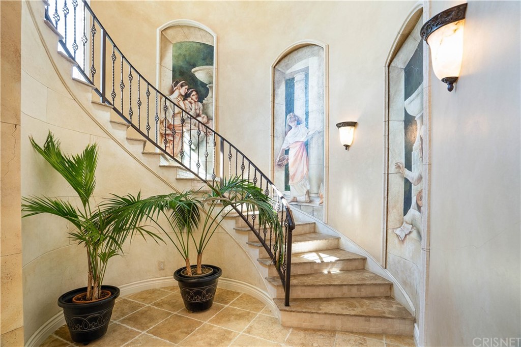 75 North Coolwater Road Bell Canyon, CA 91307 - Photo 7 of 72 a view of staircase with lots of frames on wall and a potted plant