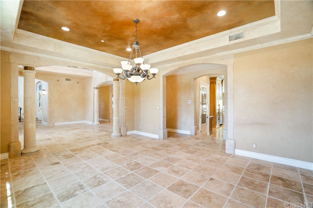 75 North Coolwater Road Bell Canyon, CA 91307 - Photo 10 of 72 a view of a hallway with wooden floor and a chandelier