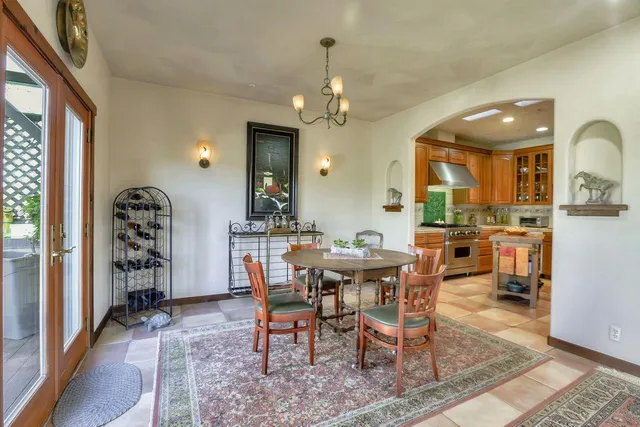 a view of a a dining room with furniture window and wooden floor