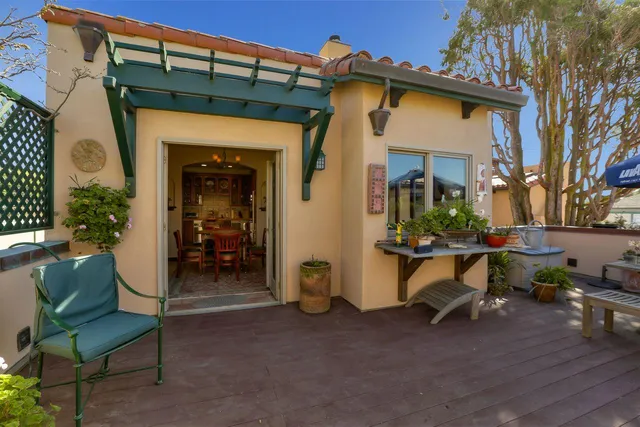 a view of a house with a porch and furniture
