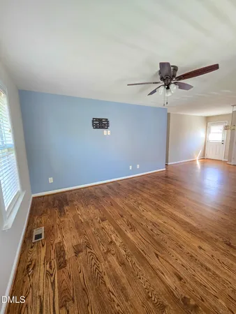 wooden floor in an empty room with a window