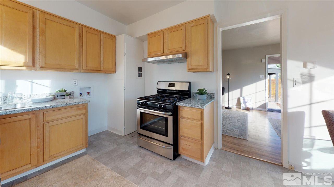 1860 Keystone Avenue Reno, NV 89503 - Photo 18 of 22 a kitchen with stainless steel appliances granite countertop a stove a sink and a microwave