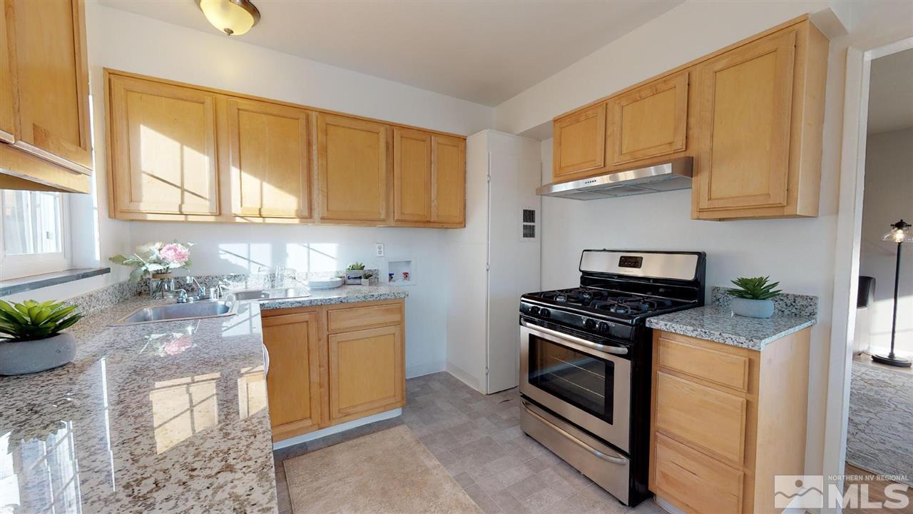 1860 Keystone Avenue Reno, NV 89503 - Photo 3 of 22 a kitchen with stainless steel appliances granite countertop a stove a sink and a white cabinets
