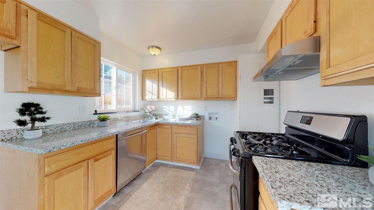 1860 Keystone Avenue Reno, NV 89503 - Photo 4 of 22 a kitchen with stainless steel appliances granite countertop a sink stove and cabinets