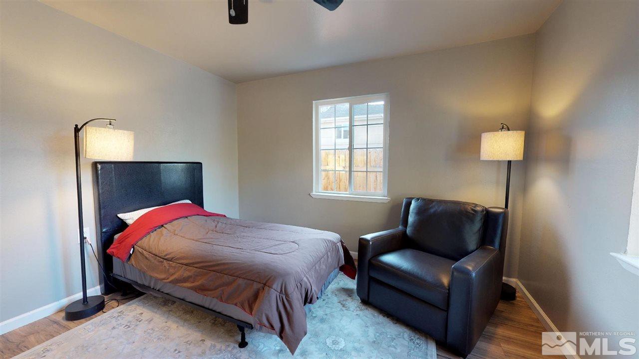1860 Keystone Avenue Reno, NV 89503 - Photo 8 of 22 a bedroom with a bed and wooden floor