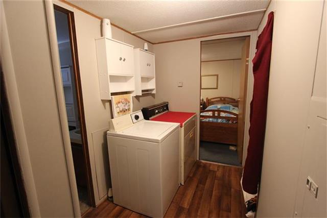 2474 Cypress Road Buchanan, TN 38222 - Photo 17 of 20 Hallway with utility space and a washer & dryer that convey.