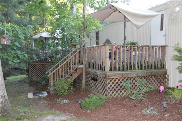 2474 Cypress Road Buchanan, TN 38222 - Photo 6 of 20 Shade trees in the back , deck along most of the back of home.