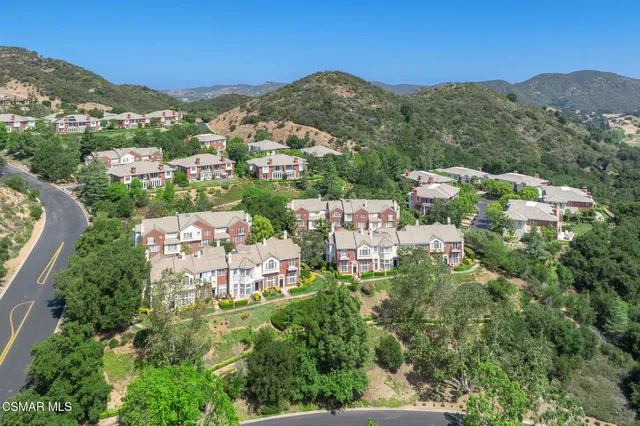 an aerial view of residential houses and outdoor space