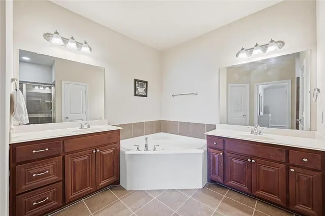 a bathroom with a glass door shower a sink and a mirror