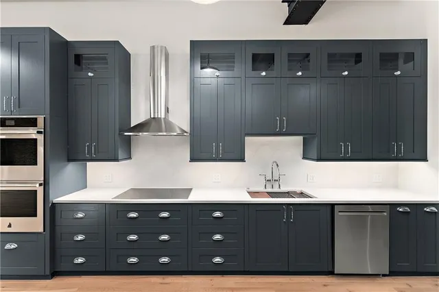 a kitchen with stainless steel appliances granite countertop a sink and a microwave