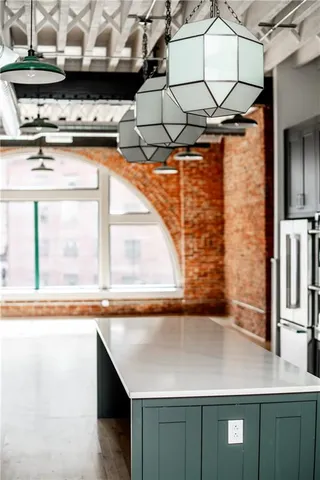 a kitchen with stainless steel appliances a refrigerator and a stove top oven