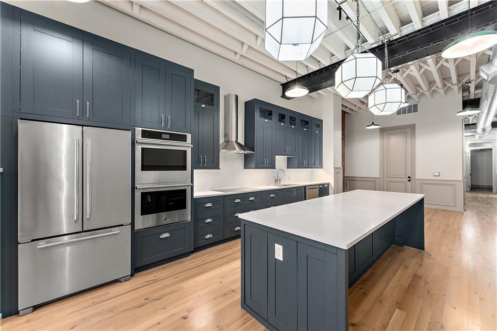 915 Liberty Avenue, Unit 701 Pittsburgh, PA 15222 - Photo 19 of 50 a kitchen with stainless steel appliances a refrigerator and a stove top oven