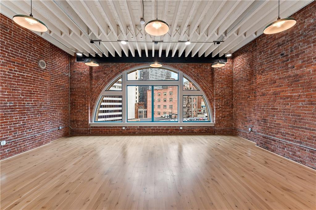 915 Liberty Avenue, Unit 701 Pittsburgh, PA 15222 - Photo 22 of 50 a view of an empty room with wooden floor and a large window