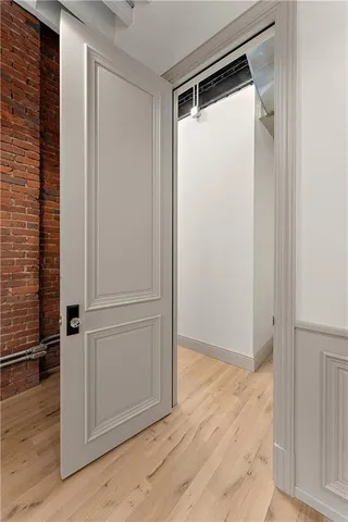 a view of a room with wooden floor and white walls