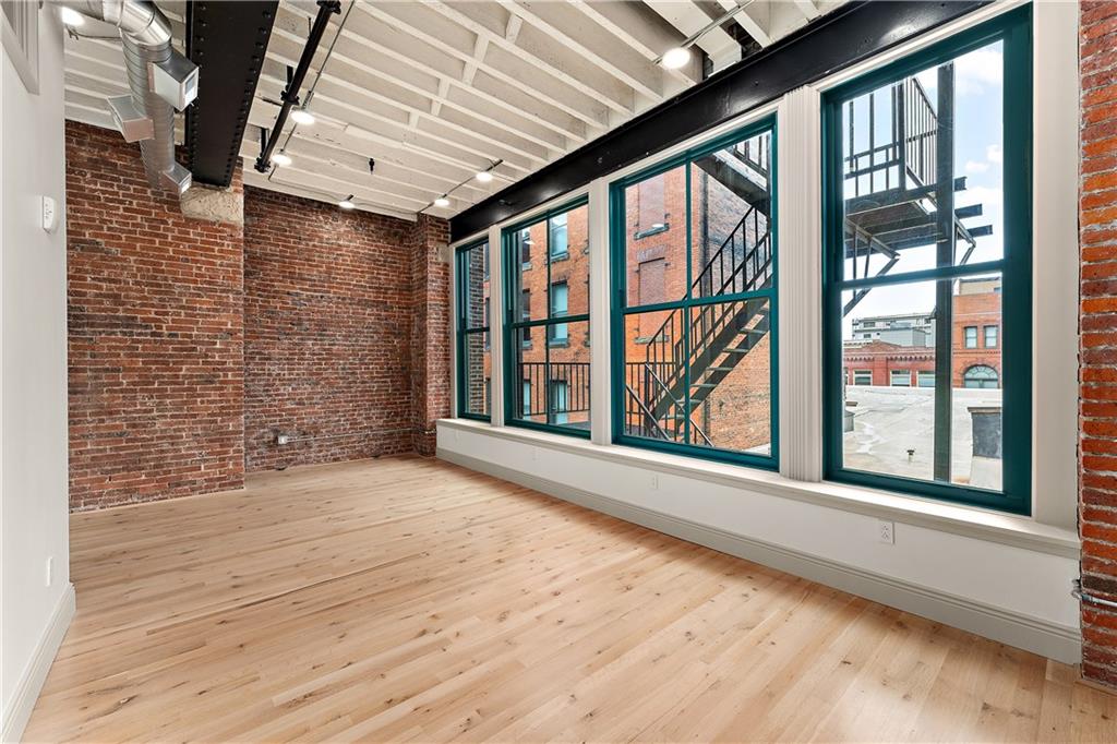 915 Liberty Avenue, Unit 701 Pittsburgh, PA 15222 - Photo 45 of 50 a view of an empty room with a window and wooden floor