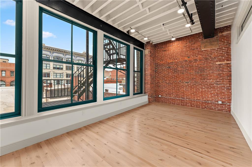 915 Liberty Avenue, Unit 701 Pittsburgh, PA 15222 - Photo 48 of 50 a view of an empty room with wooden floor and a window