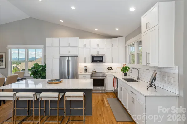 a kitchen with counter top space appliances and cabinets