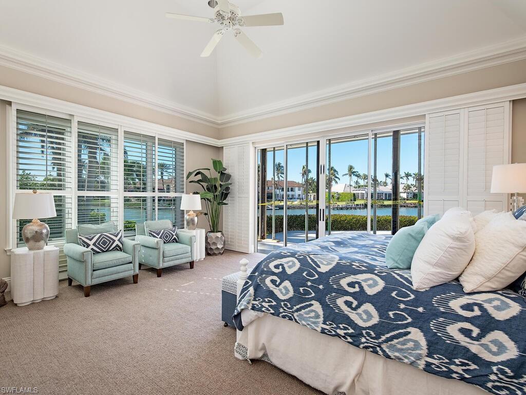 3630 Rum Row Naples, FL 34102 - Photo 11 of 28 a bedroom with furniture and large windows