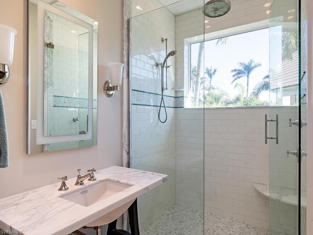3630 Rum Row Naples, FL 34102 - Photo 13 of 28 a bathroom with a shower and a sink