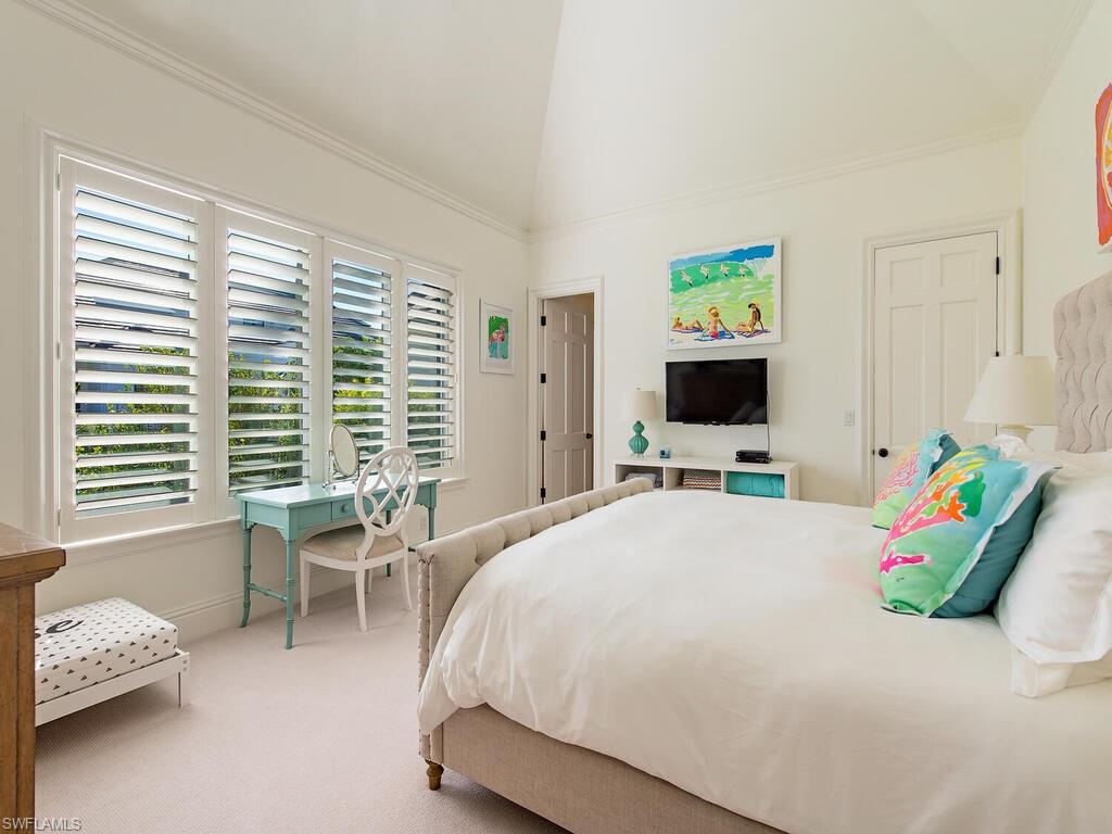 3630 Rum Row Naples, FL 34102 - Photo 17 of 28 a bedroom with a bed and a flat screen tv