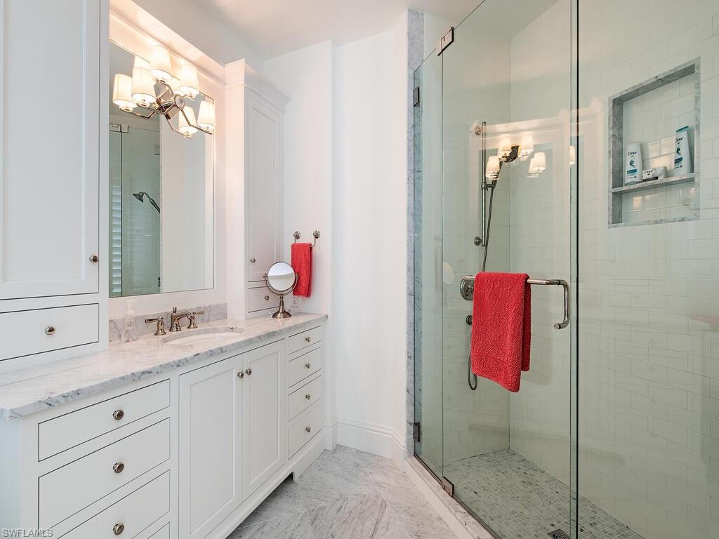 3630 Rum Row Naples, FL 34102 - Photo 18 of 28 a bathroom with a sink vanity and a mirror