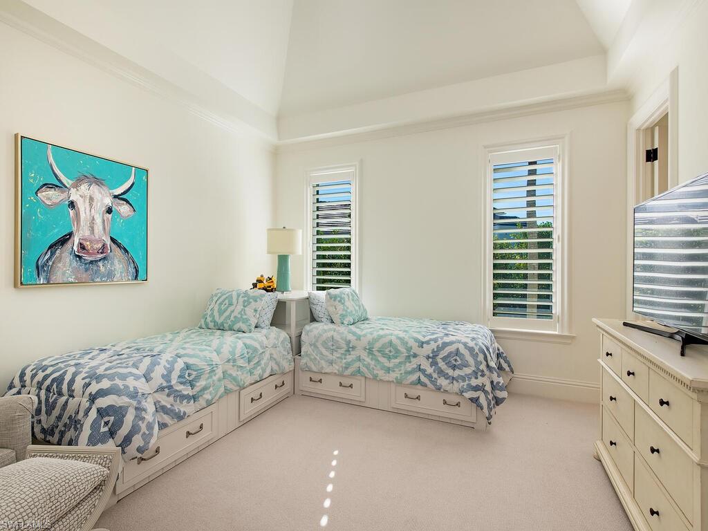 3630 Rum Row Naples, FL 34102 - Photo 19 of 28 a bedroom with a bed and a couch