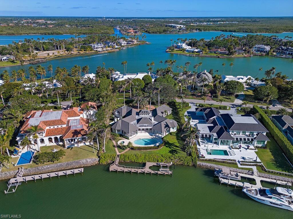3630 Rum Row Naples, FL 34102 - Photo 28 of 28 an aerial view of a city with lots of residential buildings ocean and mountain view in back