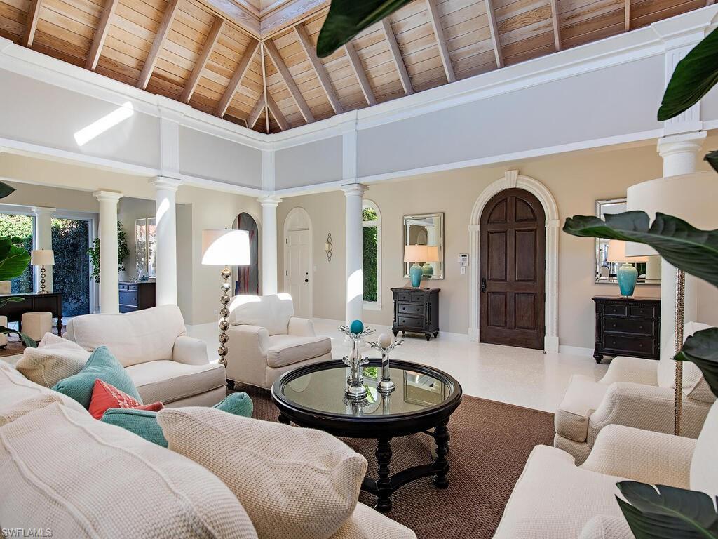 3630 Rum Row Naples, FL 34102 - Photo 4 of 28 a living room with furniture and a chandelier