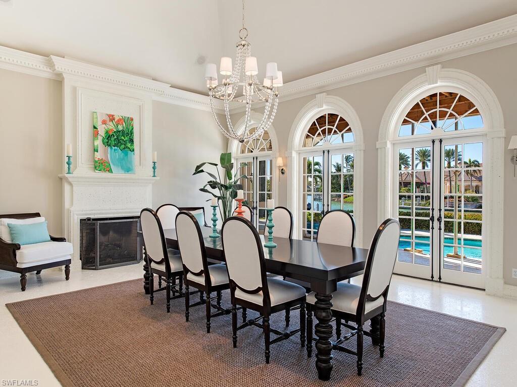 3630 Rum Row Naples, FL 34102 - Photo 8 of 28 a view of a dining room with furniture a chandelier and wooden floor