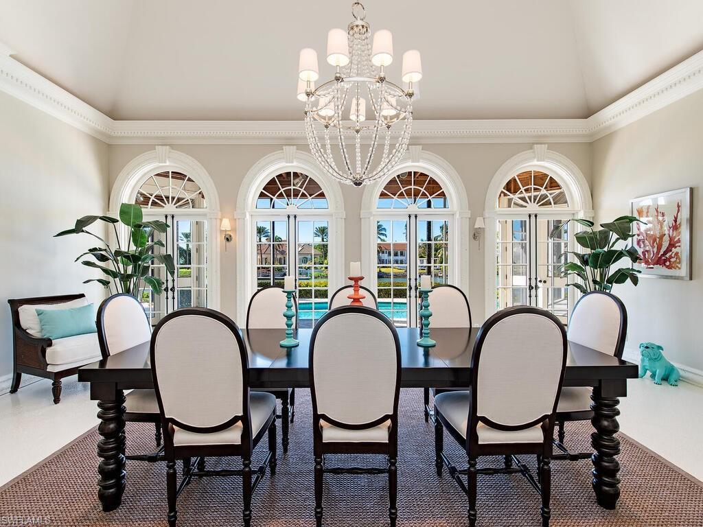 3630 Rum Row Naples, FL 34102 - Photo 9 of 28 a view of a dining room with furniture window and wooden floor