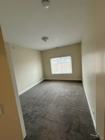 an empty room with a empty space and windows