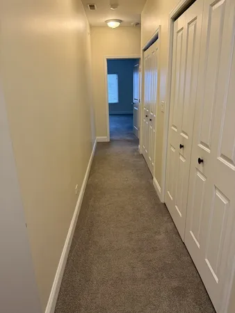 a view of closet with wooden floor