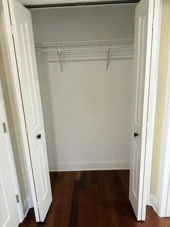 a bathroom with a granite countertop toilet and a sink