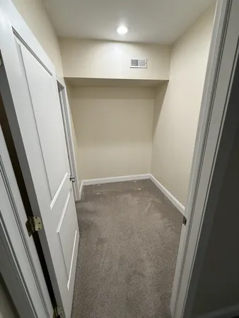 wooden floor in an empty room with a sink