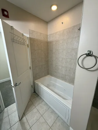 a bathroom with a tub a toilet and a shower