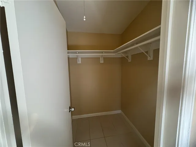 a view of a utility room with cabinets