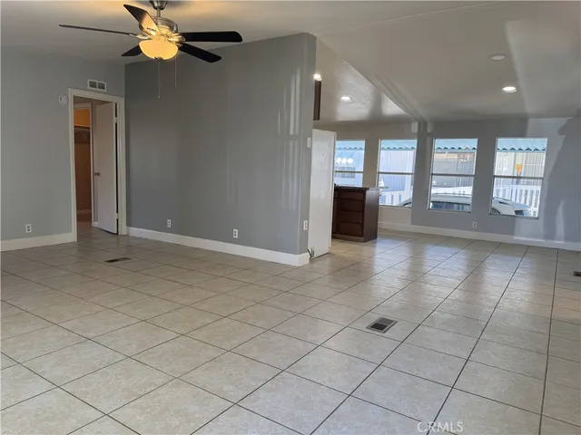 a kitchen with granite countertop a stove a sink and a refrigerator