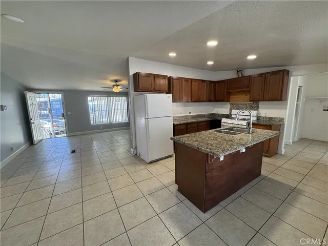 a kitchen with stainless steel appliances granite countertop a stove a refrigerator and a oven