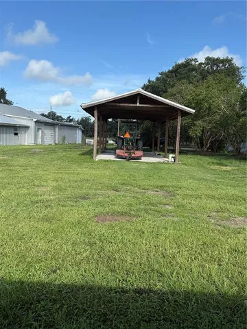 a view of a green yard with trees