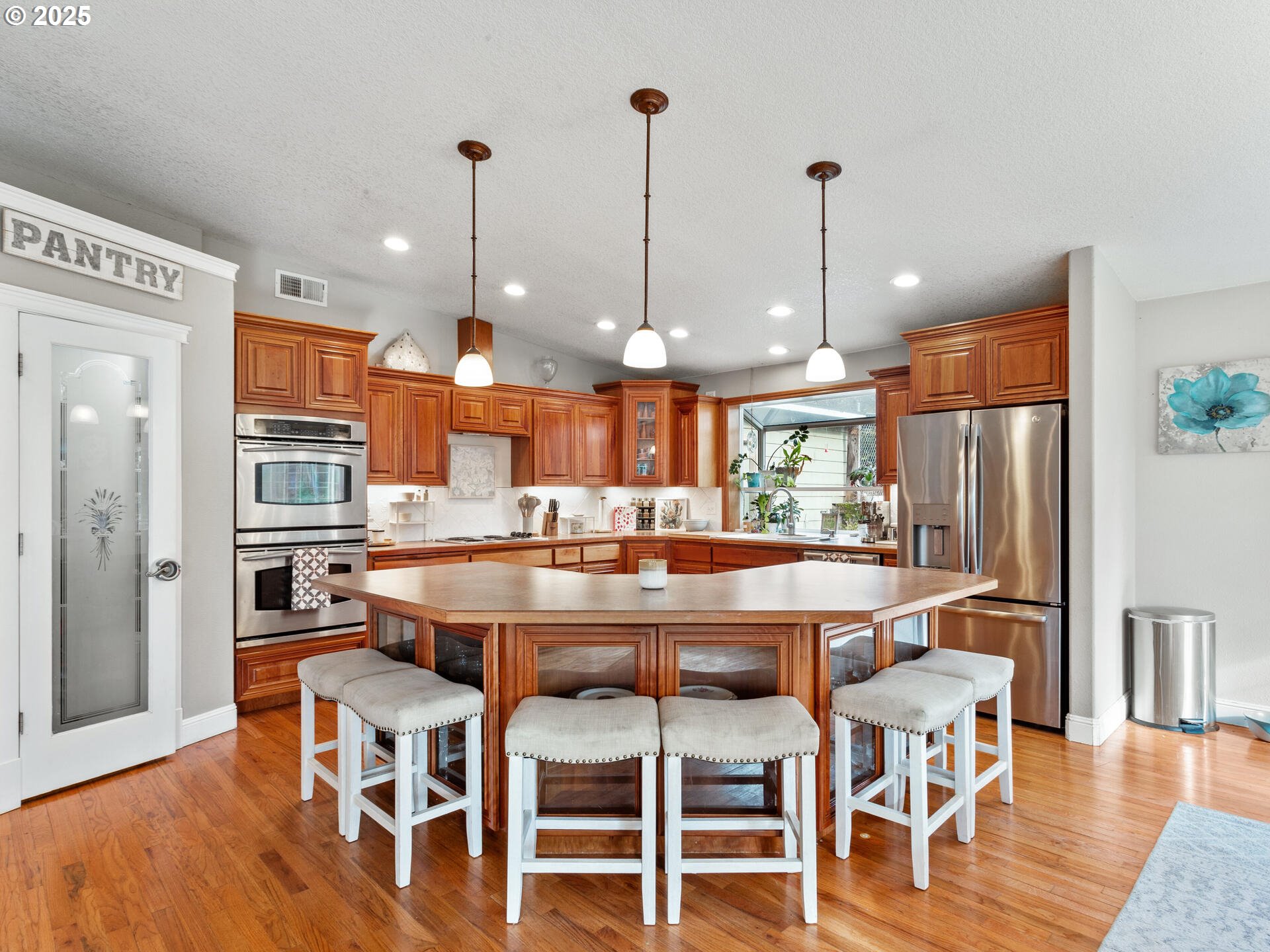 1621 Northeast 194th Street Ridgefield, WA 98642 - Photo 19 of 48 a dining table chairs wooden floor and a kitchen view
