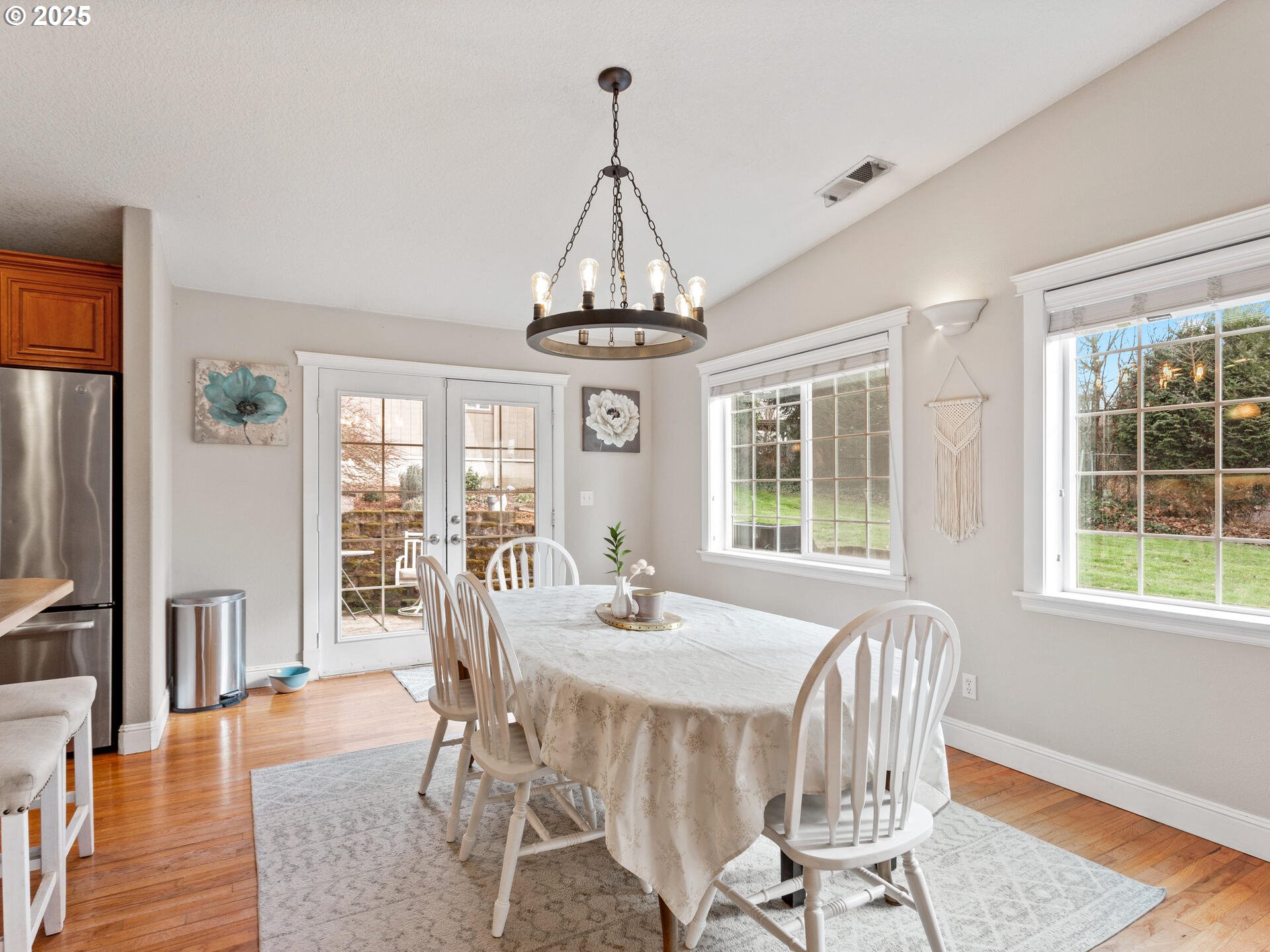 1621 Northeast 194th Street Ridgefield, WA 98642 - Photo 22 of 48 a dining room with wooden floor a chandelier a glass table and chairs