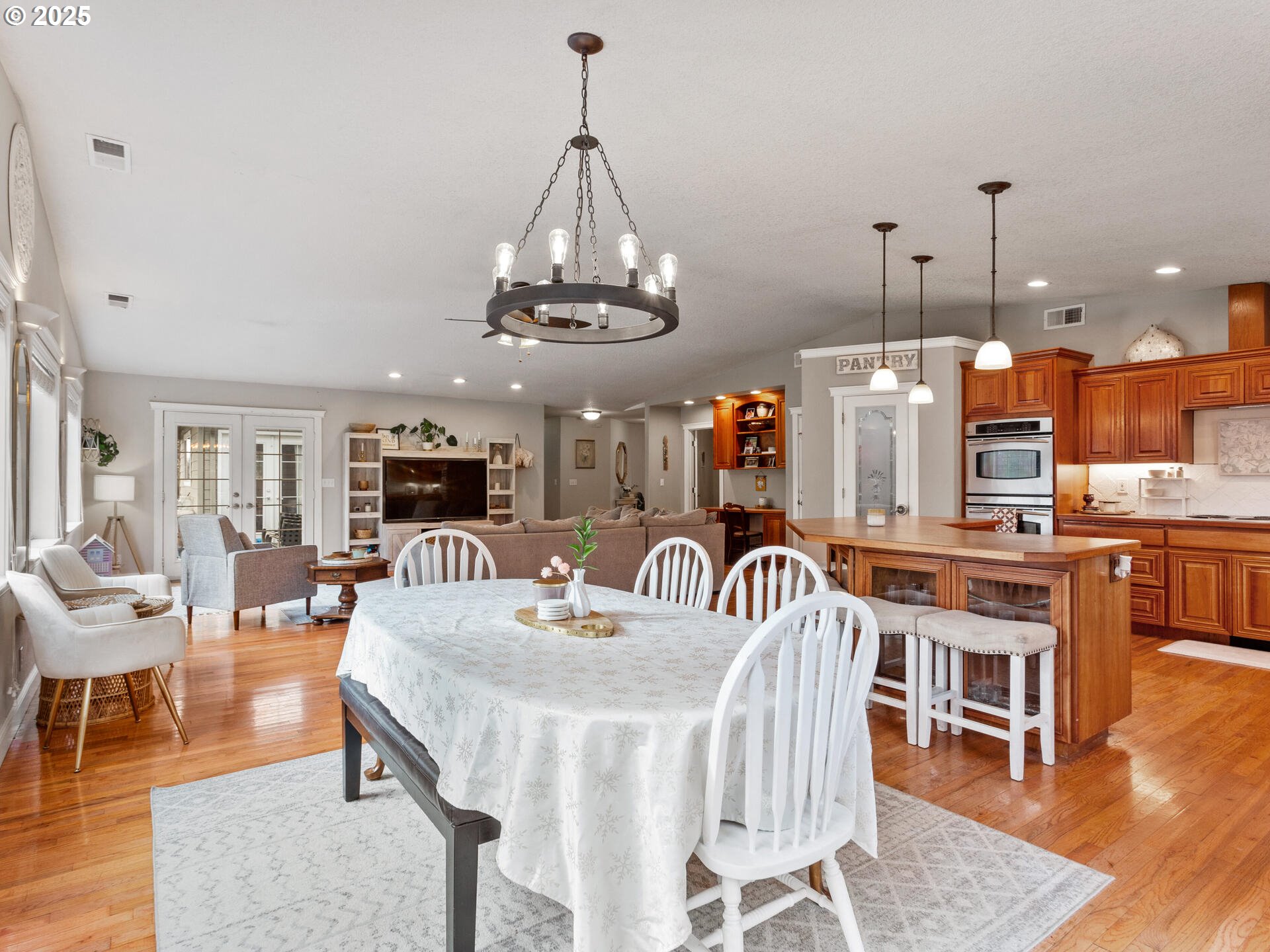 1621 Northeast 194th Street Ridgefield, WA 98642 - Photo 23 of 48 a view of a dining room and livingroom with furniture wooden floor a chandelier