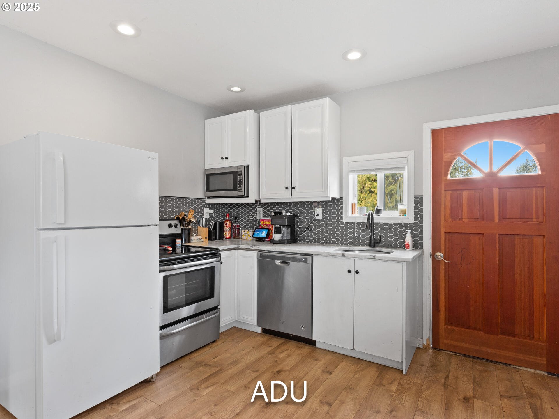 1621 Northeast 194th Street Ridgefield, WA 98642 - Photo 43 of 48 a kitchen with cabinets stainless steel appliances and wooden floor